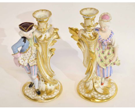 Pair of late 19th century Paris porcelain candlesticks, richly gilt decorated modelled with a lady and a gentleman aside each