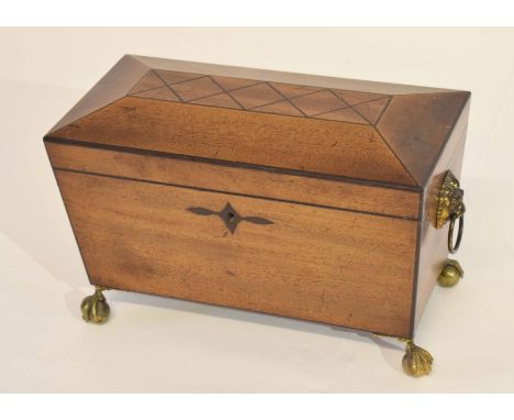 19th century mahogany sarcophagus shaped tea caddy, the interior fitted with three sliding lidded compartments on brass claw 
