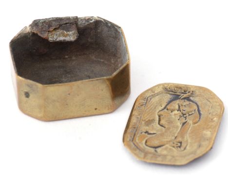 Early 19th century tinned brass pill box of hinged rectangular form with canted corners (hinge a/f), the lid embossed with a 