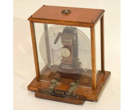 Measuring machine for electric current by The Electrical Company Manchester, in light oak frame, 28cm high