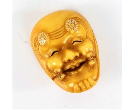 Japanese ivory Noh mask netsuke, the mask with flower heads to the forehead, 3.5cm high