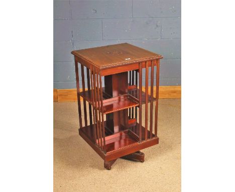 Edwardian mahogany revolving bookcase, the top with marquetry inlaid top with a border, each side with four splats with one s