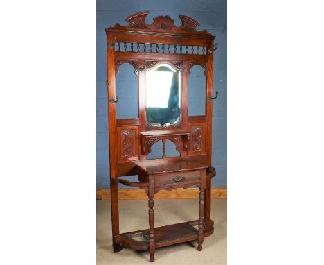 Victorian mirrored hallstand, having broken arch pediment above a shaped bevelled mirror, fitted single drawer below and flan