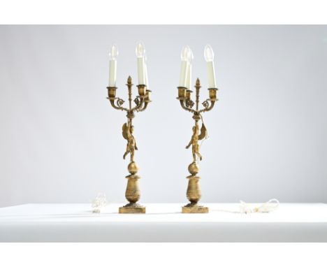 A pair of French gilt bronze three-light candlesticks with a cherub, 19th C.H 62 cm 
