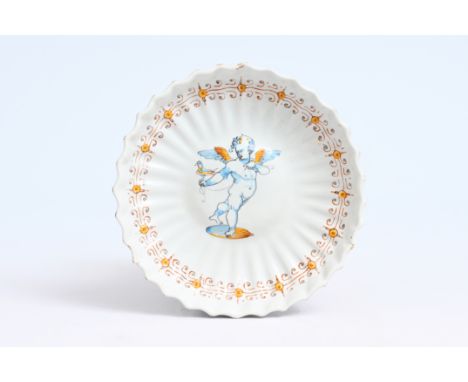 A polychrome Italian maiolica crespina with a putto holding a bird, Faenza, 17th C.D 23,5 cm