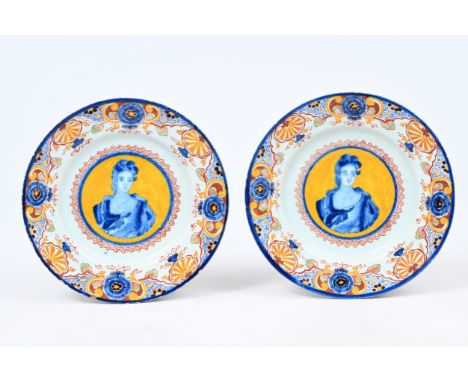 A pair of rare Dutch Delft polychrome yellow-ground 'portrait' plates, 18th C.Dia.: 22 cm