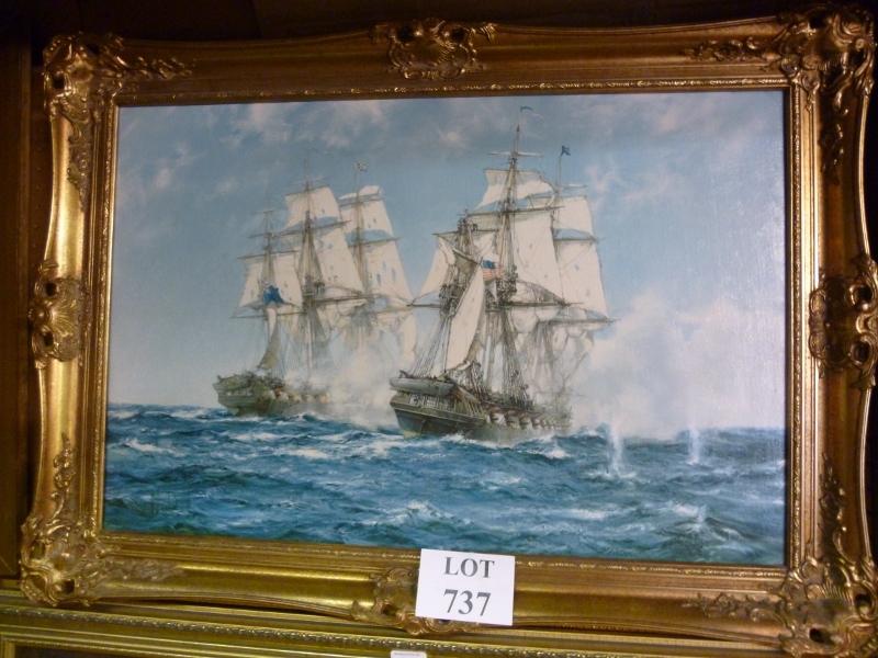 A gilt framed Montague Dawson print of two battle ships at sea bears