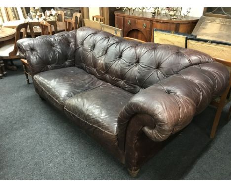 A brown button leather Chesterfield settee 