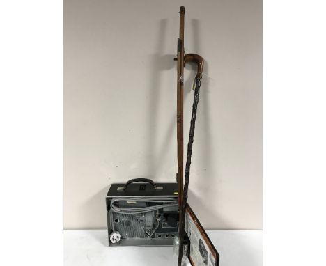 A cased Videotronic 8mm projector, two piece split cane rod and reel, walking stick 