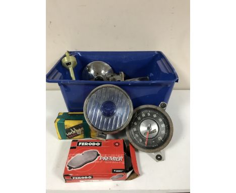 A box of assorted car parts - head lamp, break pads, speedometer, bottle jack, towing belts, copper grease etc 