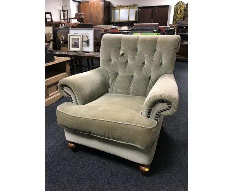A Victorian style green button dralon armchair 