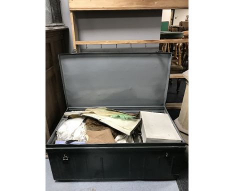 A metal trunk containing a quantity of vintage clothing.  