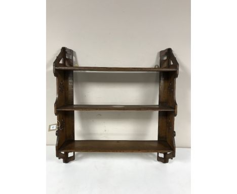 A carved oak wall shelf 