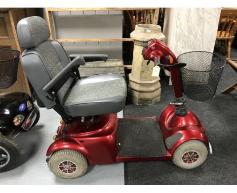 A Pride disability cart, key, charger and manual 