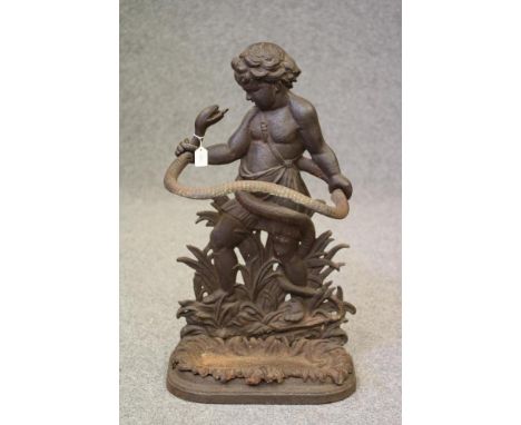 A VICTORIAN CAST IRON STICK STAND modelled as a Putto (possibly the young Hercules) standing amongst foliage and holding a se