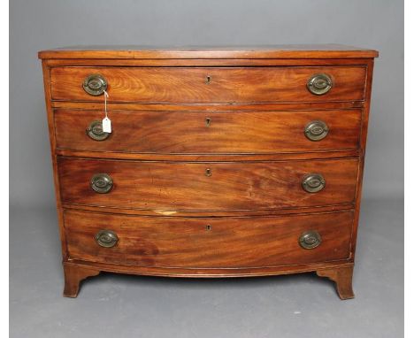 A REGENCY MAHOGANY BOWED CHEST, early 19th century, of four graduated cockbeaded drawers with later brass oval handles, mould
