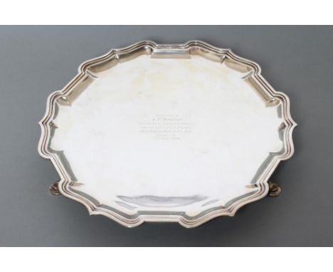 A STERLING SILVER SALVER, maker Hamilton & Co., India, c.1939, of shaped circular form with pie-crust rim, raised upon three 
