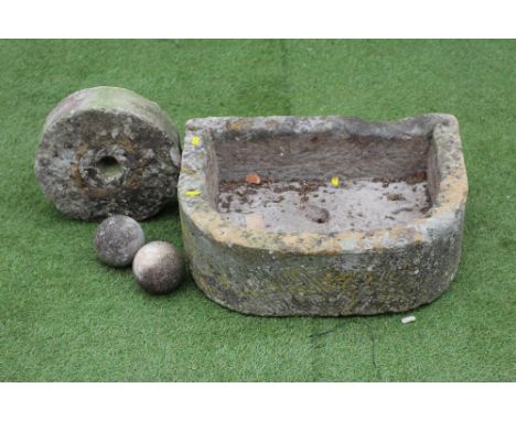 A SMALL SANDSTONE TROUGH OF D FORM, finely cut, 21 1/2" x 16 1/2" x 7 1/2", together with a small mill wheel, 11 1/4" wide, a