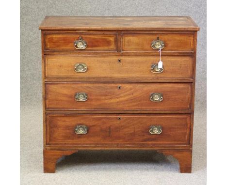 A GEORGIAN MAHOGANY STRAIGHT FRONTED CHEST, c.1800, crossbanded with stringing, the banded top with moulded edge with chequer