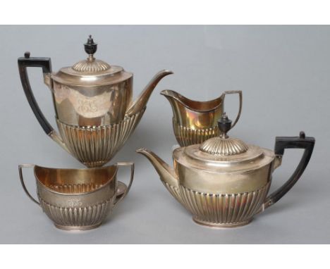 AN EDWARDIAN SILVER FOUR PIECE TEA AND COFFEE SERVICE, maker Goldsmiths & Silversmiths Co. Ltd., London 1905, of semi fluted 