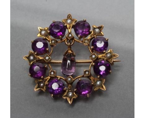 AN EDWARDIAN AMETHYST BROOCH, the open circlet claw set with eight facet cut circular stones with seed pearl spacers, central