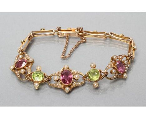 AN EDWARDIAN BRACELET, the upper section open back collet set with three oval facet cut tourmalines and two circular peridots