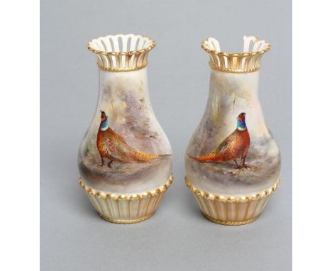 A PAIR OF ROYAL WORCESTER CHINA VASES, 1905/6, of baluster form with arcade moulded base and pierced everted rim, painted in 