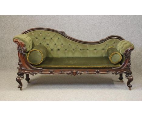 A WILLIAM IV ROSEWOOD SOFA, the show wood frame carved with flowers and scrollwork, button upholstered in green velvet, shape