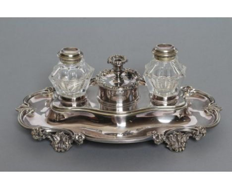 A LATE VICTORIAN EPNS DESK STAND, maker Elkington, the quatrefoil base with scroll rim centred by a pair of panel cut glass i