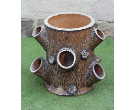 A VICTORIAN EARTHENWARE STRAWBERRY PLANTER, modelled as a tree trunk, 14 1/2" x 21 1/2"Loss to two of the openings, and very 