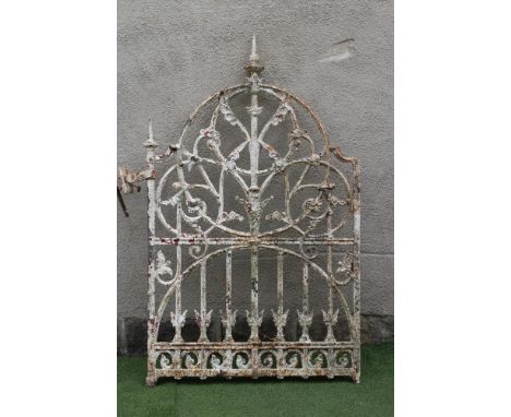 A VICTORIAN CAST IRON PEDESTRIAN GATE, the arched crest with turned finials, the upper part with foliate scrolls within a cir