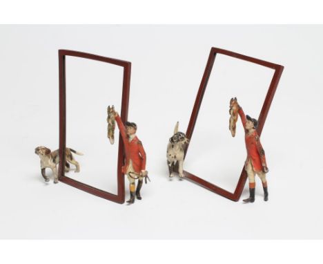 A PAIR OF COLD PAINTED METAL MENU/PHOTOGRAPH FRAMES, c.1920's/30's, each vertical oblong frame supported by a huntsman holdin