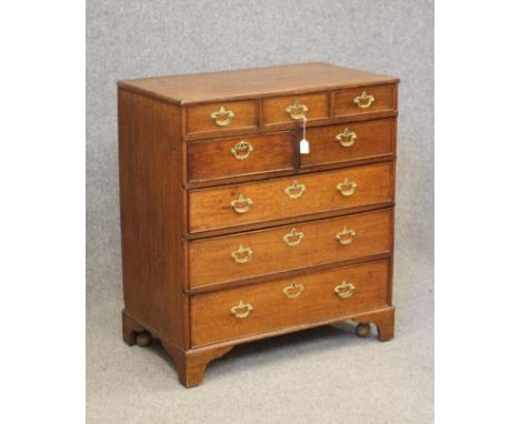 A GEORGIAN OAK CHEST, early/mid 18th century, the moulded edged top over three small frieze drawers, two short over three lon