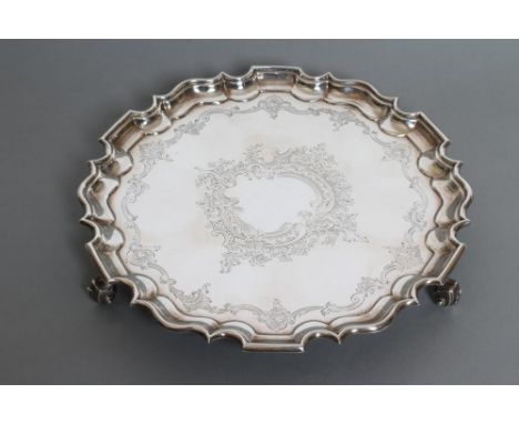 AN EDWARDIAN SILVER SALVER, maker Ackroyd Rhodes, London 1910, of shaped circular form with pie-crust rim, bright cut engrave