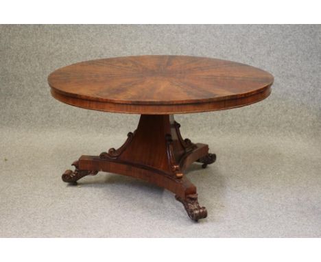 AN EARLY VICTORIAN MAHOGANY CENTRE TABLE, the moulded edged radially veneered top and plain frieze raised on spreading triang