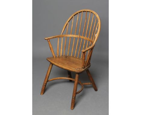 AN ASH STICK BACK WINDSOR ARMCHAIR, early 19th century, the hoop back over bowed seat, baluster turned arm supports, on splay