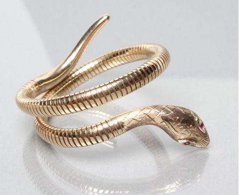 A VICTORIAN STYLE 9CT GOLD SERPENT BANGLE, the steel sprung coiled body with scale engraved head inset with two ruby chip eye