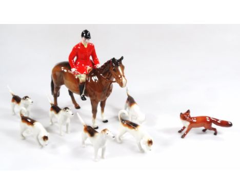 A Beswick hunting group, comprising red jacketed huntsman, 20cm H, fox, and six various hounds. (a quantity)