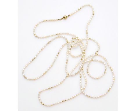 A natural pearl single strand necklace, on 9ct gold clasp, with 9ct gold breaks, each bead approx. 4mm.