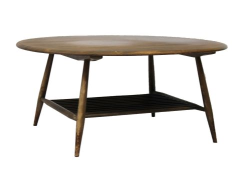 A retro Ercol style light wood coffee table, the oblong top raised on cylindrical supports with newspaper rack beneath, 45cm 