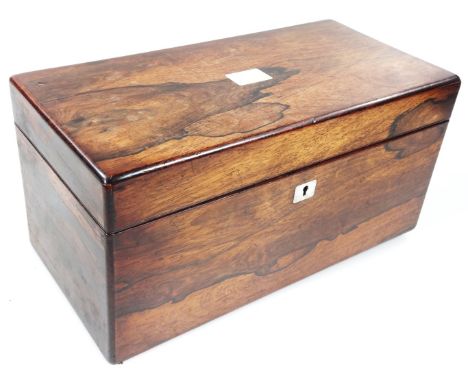 An early 19thC rosewood tea caddy, of rectangular outline, the hinged lid revealing a single tea aside open space, centred by