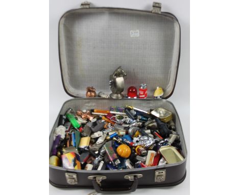 Various novelty lighters, to include pocket and others, astronaut lighter, 10cm H, etc, contained in a travel case.