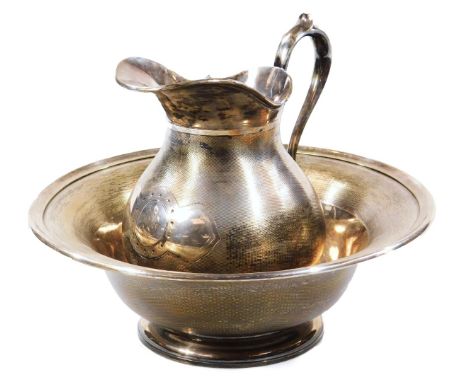 An early 20thC Christofle jug and bowl, each with a repeat engine turned decoration, the jug with thumb mould handle and a bu