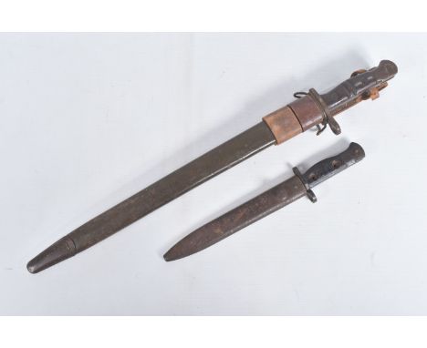 A 1907 PATTERN REMINGTON BAYONET AND A BRITISH JUNGLE CARBINE BAYONET, the Remington Bayonet has the makers stamp and the yea
