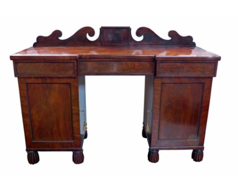 Early 19th century mahogany  twin pedestal sideboard circa 1830.  Back board with double scroll decoration sitting on rectang