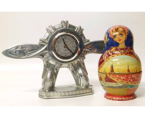 Jarsaparilla Quartz aeroplane clock and Russian stacking dolls. Condition report: see terms and conditions.