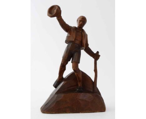 Circle of Otto Moroder (1894-1977),  Male Bavarian figure waving a hat and holding a walking stick, carved wooden sculpture, 