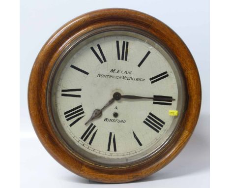 Circular oak cased school type wall clock with black and white dial, inscribed M.Elam, Northwich, Middlewich and Winsford. Co
