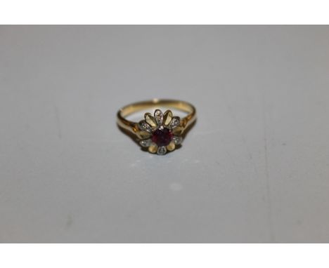 AN UNUSUAL LADIES 'FLOWER' RING WITH CENTRAL RUBY AND DIAMOND ACCENTS