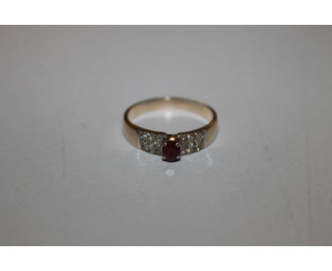 A YELLOW METAL RUBY AND DIAMOND RING WITH CENTRAL RAISED  CLAW SET RUBY FLANKED BY NINE BRILLIANT CUT DIAMONDS EITHER SIDE